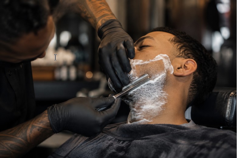 A barber giving a traditional straight razor shave in the East Village.